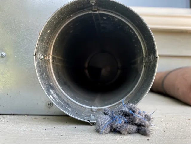San Clemente Dryer Vent Cleaning technician using specialized equipment to clear severe dryer vent blockage in San Clemente